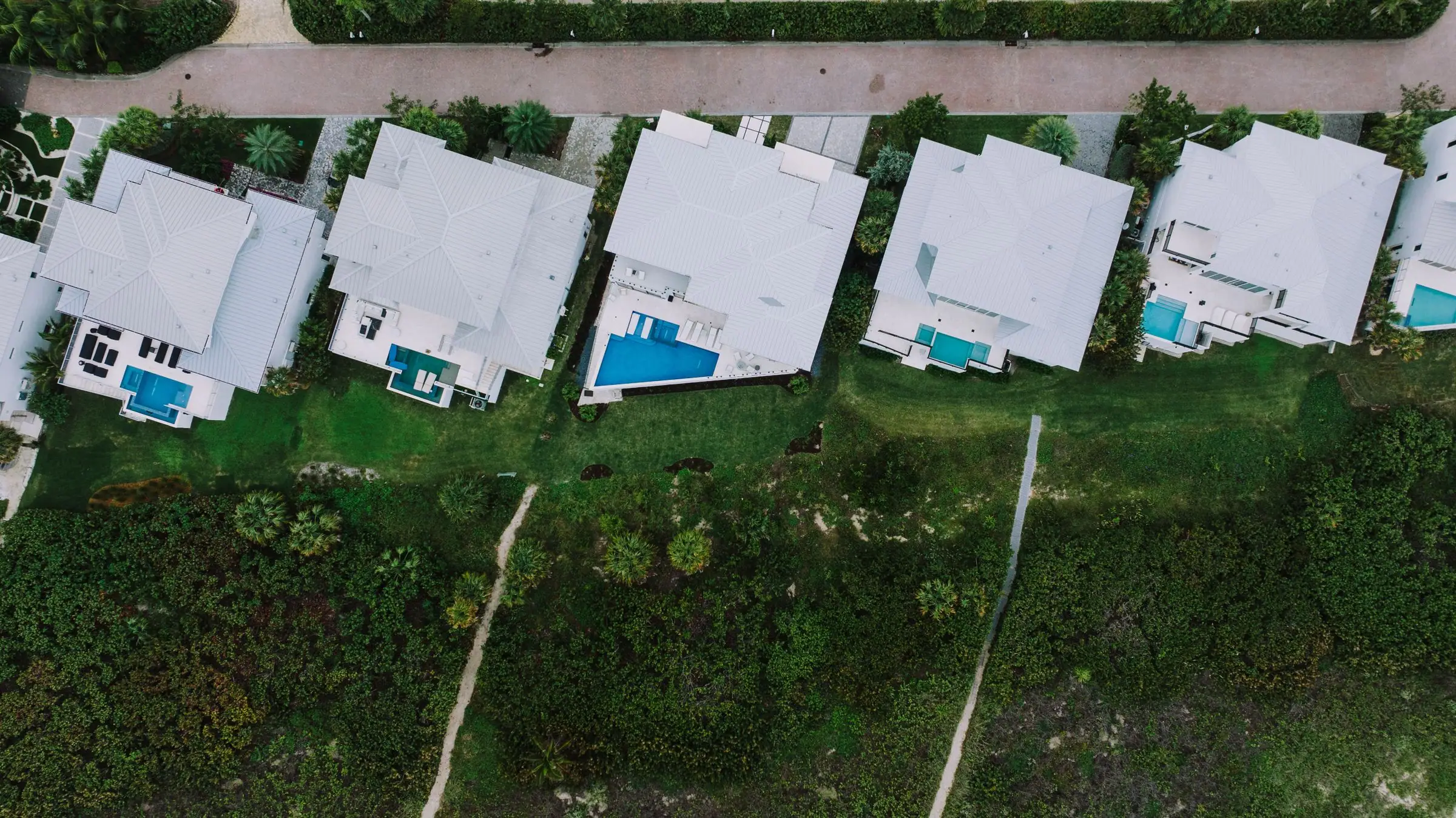 Aerial view of Florida homes, each with a pool in the back yard
